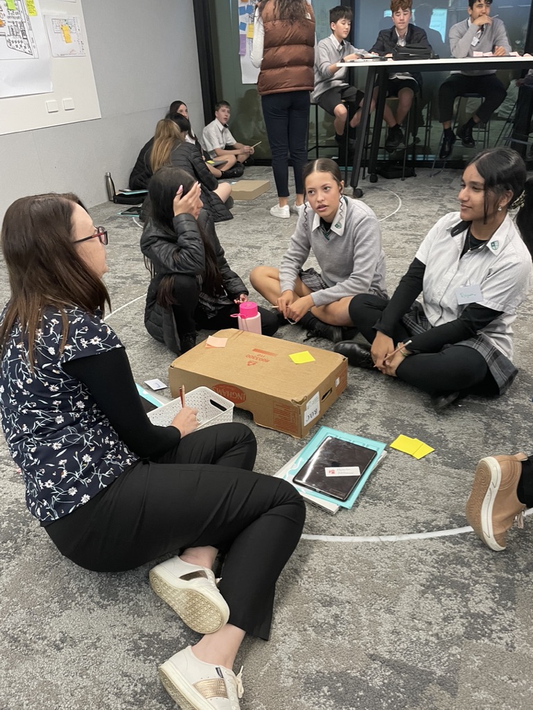 students collaborating with researcher