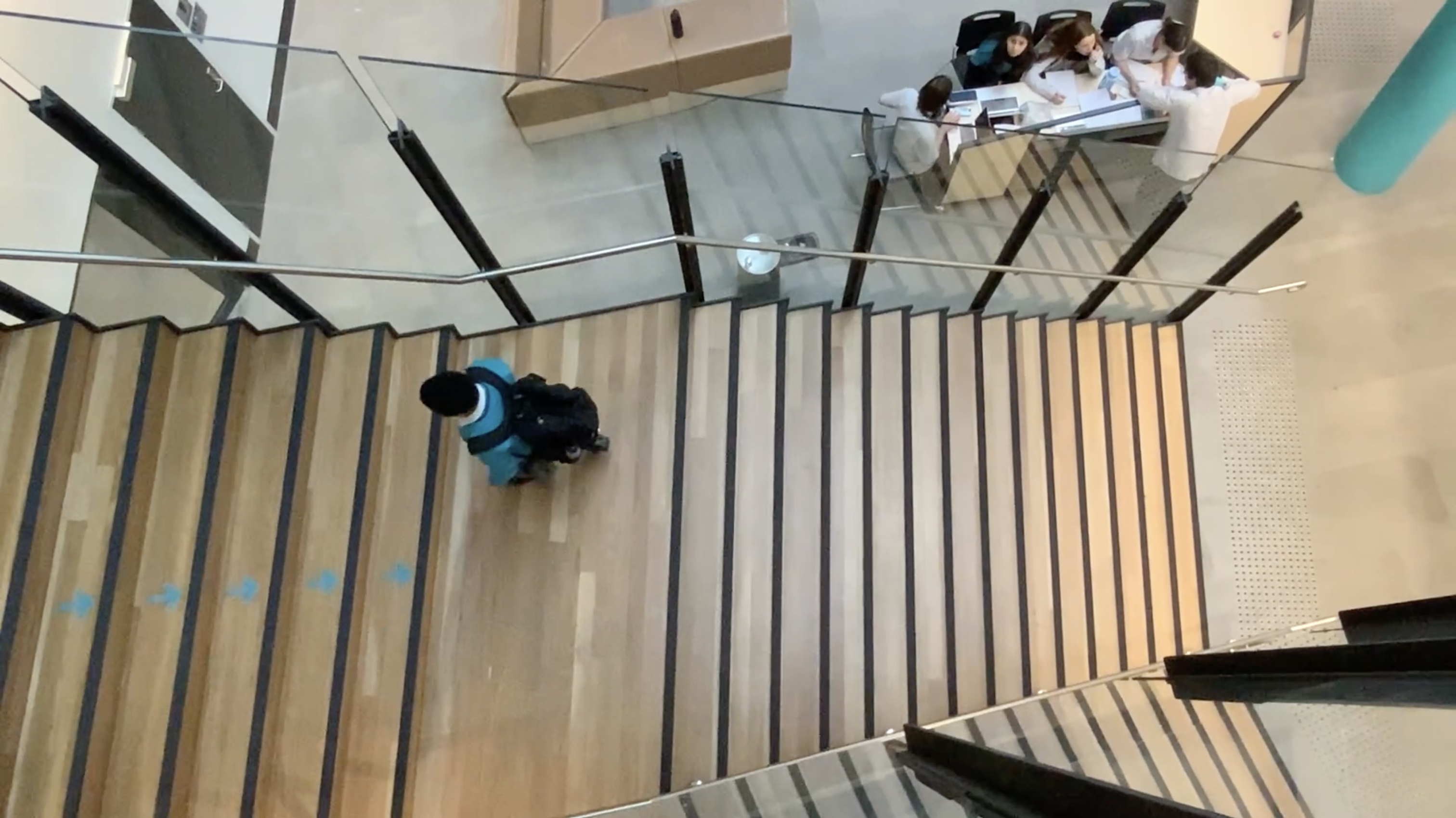 top-down view of a student walking up stairs