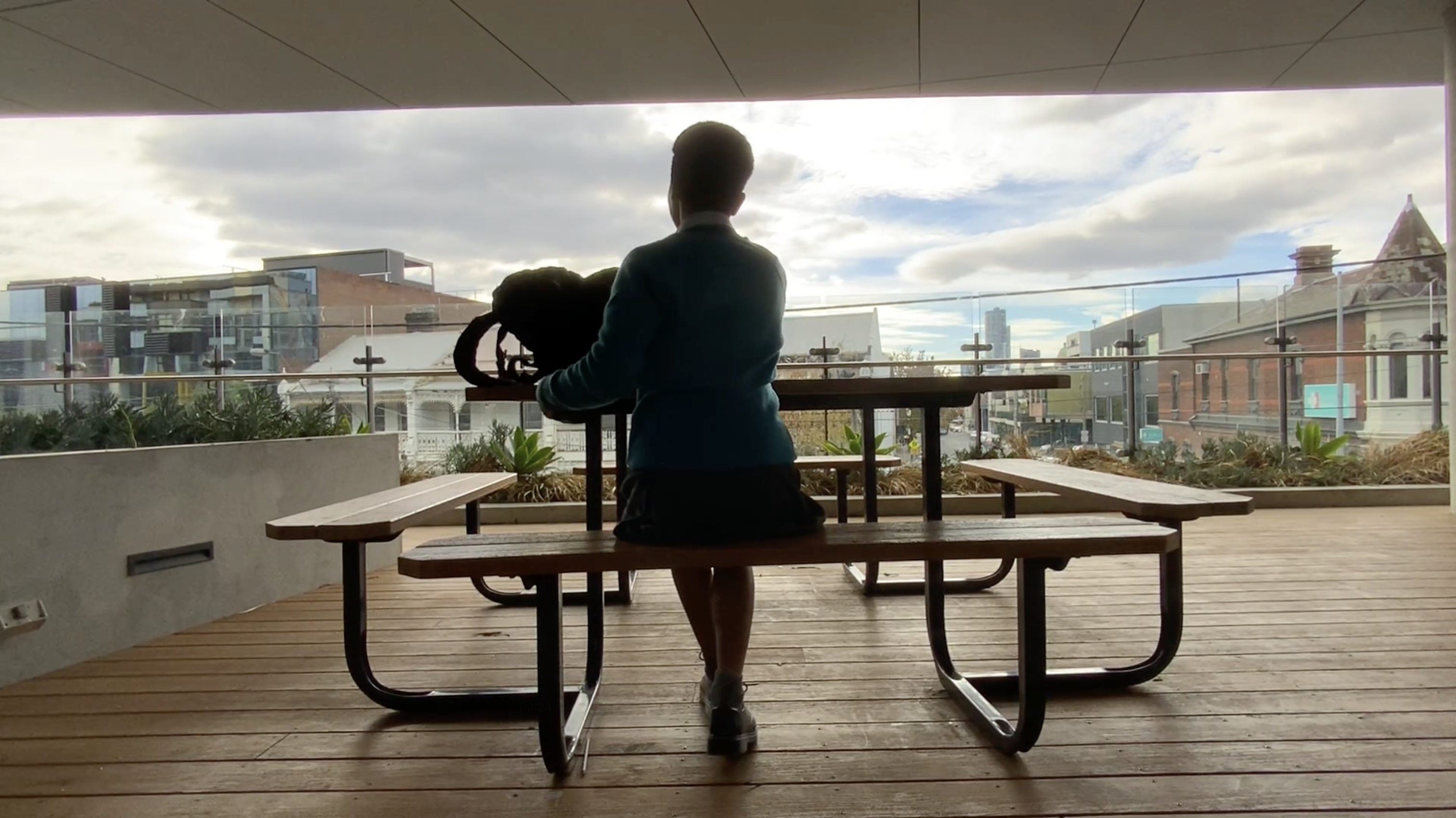 a student sitting on a balcony